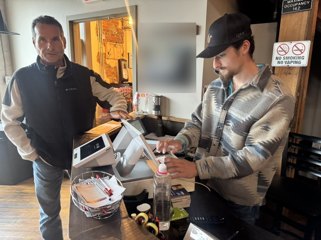 JadaPay team walking staff through a POS system at a local taproom counter